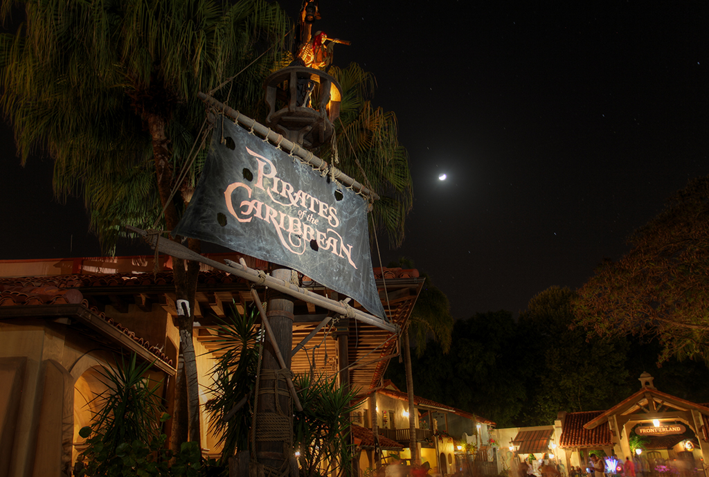 Pirates of the Caribbean ride queue featuring barrels, crates, and a crow's nest